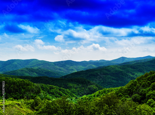 Horizontal vivid fresh hills landscape with cloudscape backgroun © spacedrone808