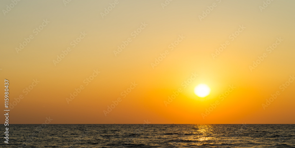 Horizontal vibrant orange ocean sunset background backdrop