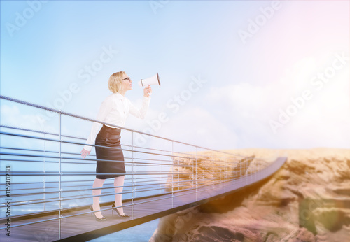 Woman on bridge using megaphone