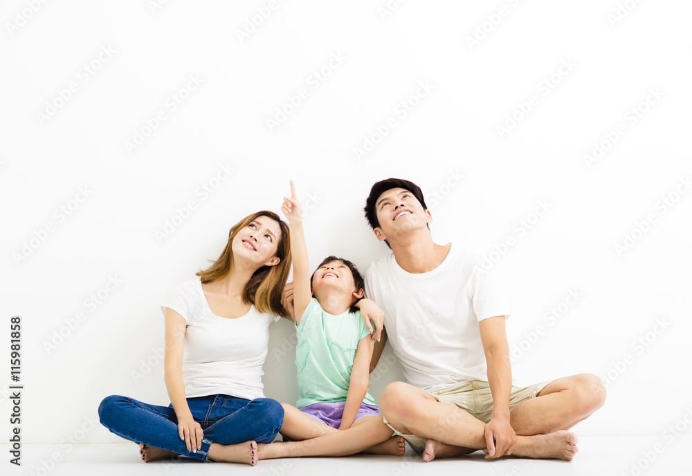 Happy Young Family pointint and looking up Happy Young Family pointint and looking up