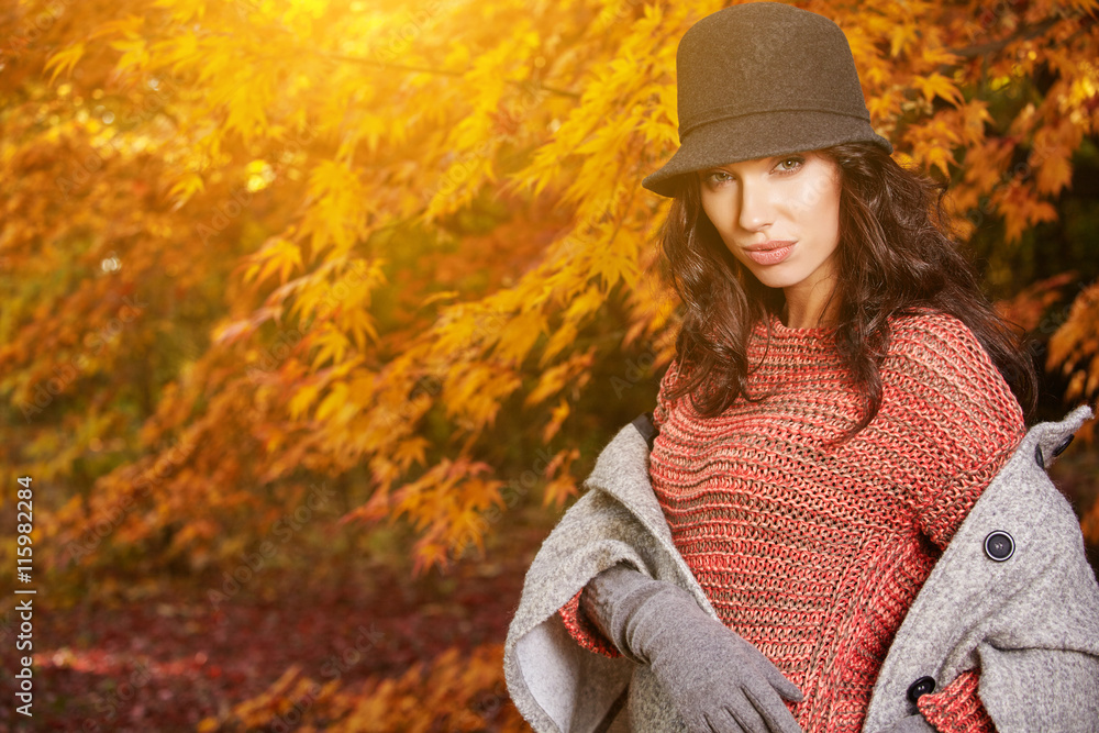 Woman in coat with hat in amazing autumn park Woman in coat with hat in amazing autumn park