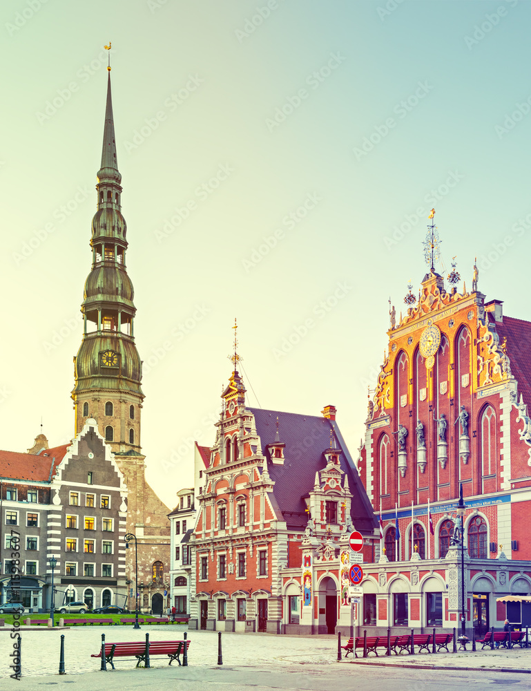 Fototapeta premium Hall town square with museum of House of Blackheads and Saint Peter church in Riga - capital and largest city of Latvia, major cultural, historical and tourist center of Baltic region