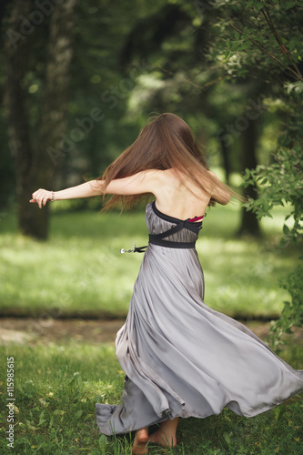 Close up Portrait, Young beautiful blonde woman in dress posing outdoors. Sunny weather