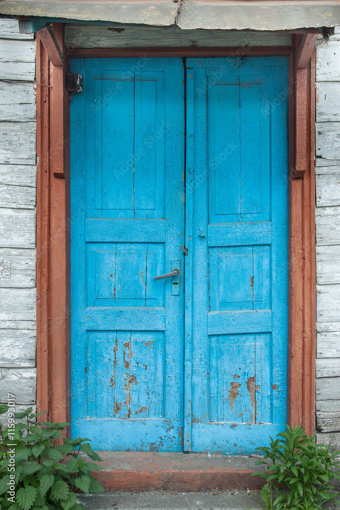 An Aged weathered blue door.