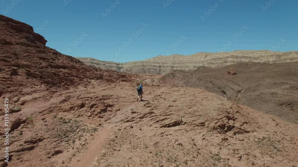 Aerial shot of hiking trails in the mountains.The camera flies past the rising climber Aerial shot of hiking trails in the mountains.The camera flies past the rising climber