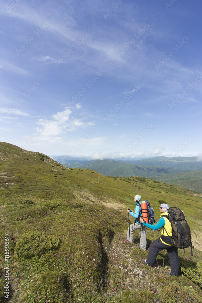 Obraz premium Summer hiking in the mountains with a backpack .