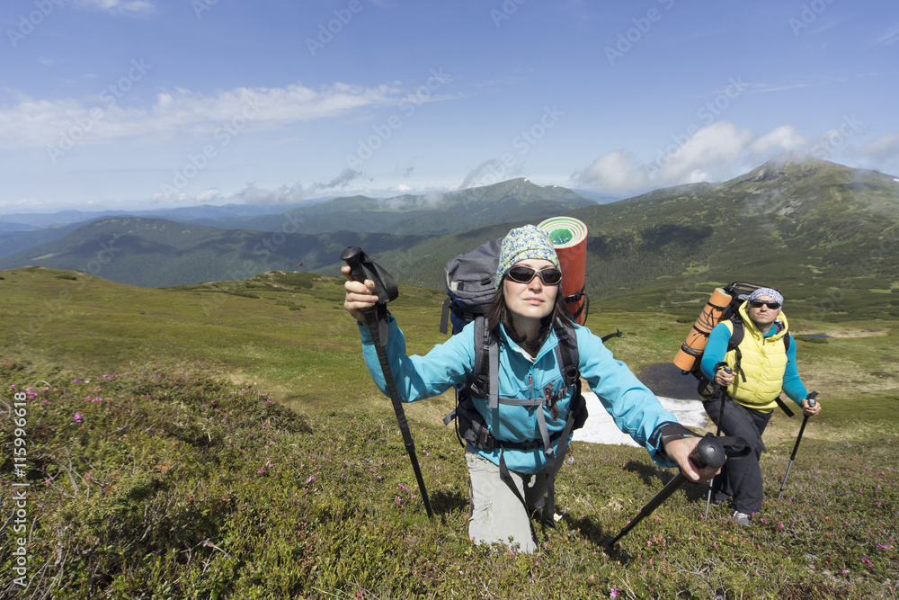 Summer hiking in the mountains with a backpack . Summer hiking in the mountains with a backpack .