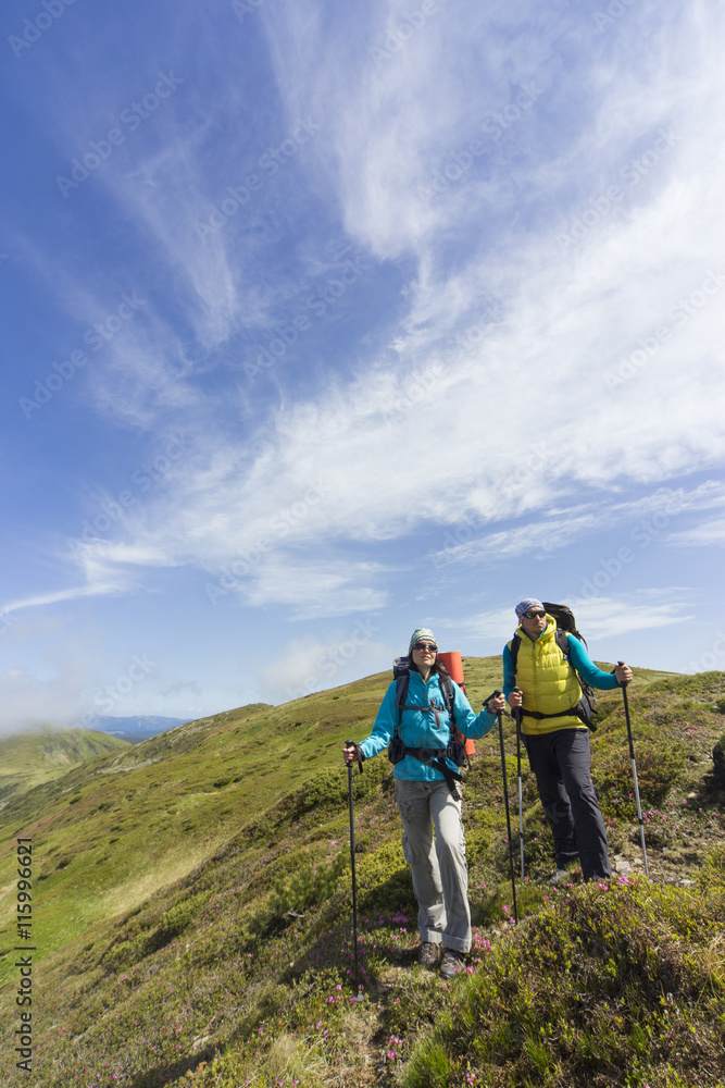 Obraz premium Summer hiking in the mountains with a backpack .
