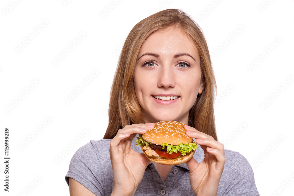I'm taking this burger down! Beautiful young woman hold burger over white background. I'm taking this burger down! Beautiful young woman hold burger over white background.