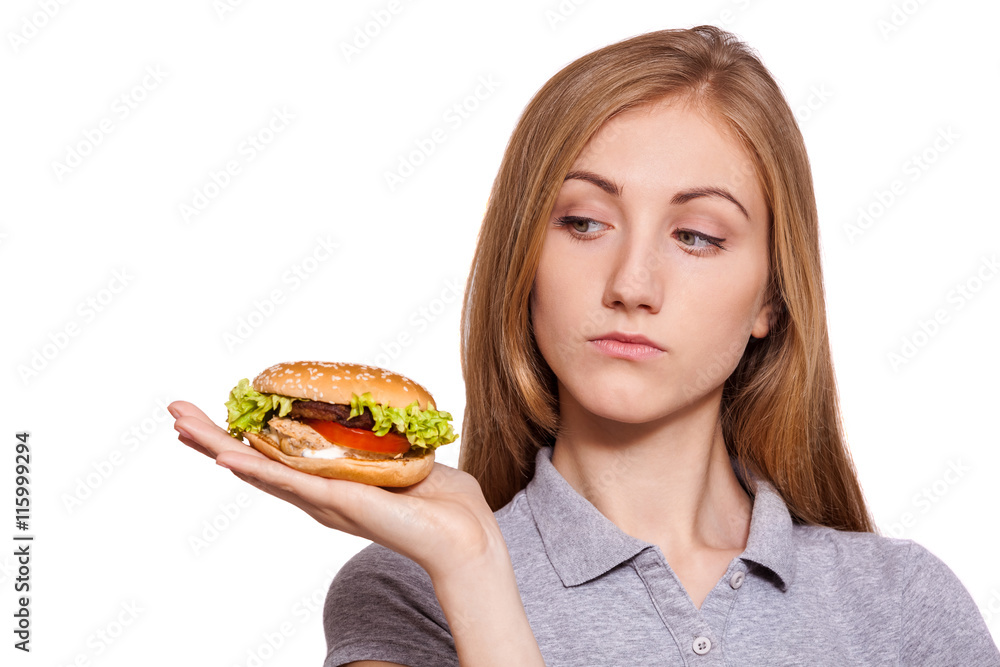 She know the secret. Pretty woman look at the hamburger with suspicious over white background. She know the secret. Pretty woman look at the hamburger with suspicious over white background.