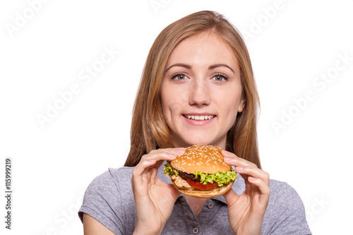 I m taking this burger down  Beautiful young woman hold burger over white background.