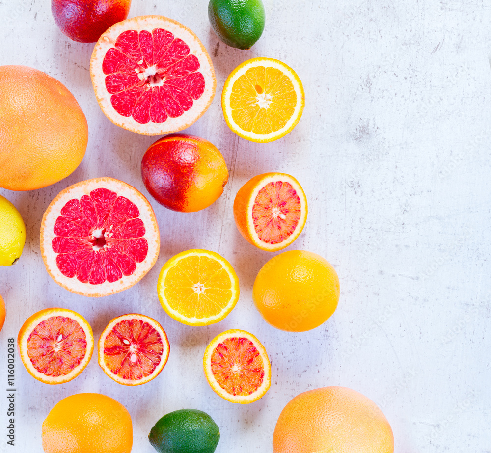 Mix of whole an cut citruses on white wooden table, top view Mix of whole an cut citruses on white wooden table, top view