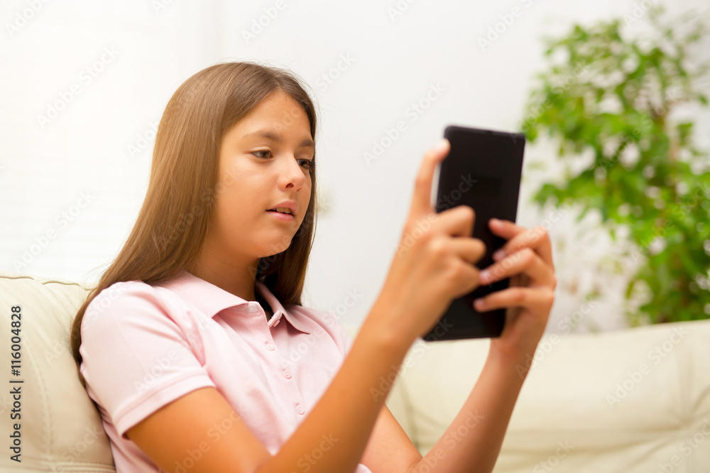 Cute little girl holding digital tablet and smiling Cute little girl holding digital tablet and smiling