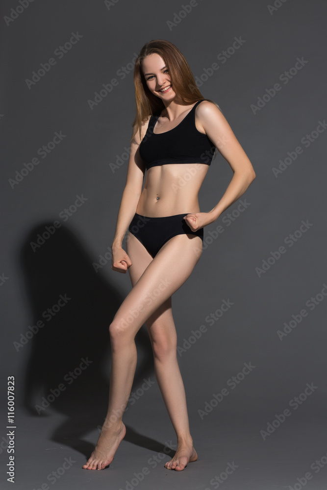 Awesome caucasian attractive sexy fashion model with natural hair, long legs, perfect skin, wearing black panties and sleeveless sports shirt, beauty photoshoot, retouched image