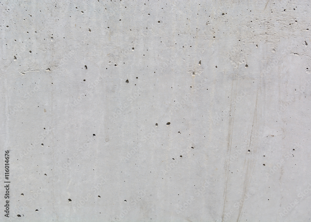 texture of gray concrete wall with small dark depressions texture of gray concrete wall with small dark depressions