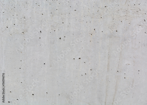 texture of gray concrete wall with small dark depressions