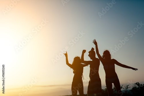 Friends partying during summer sunset