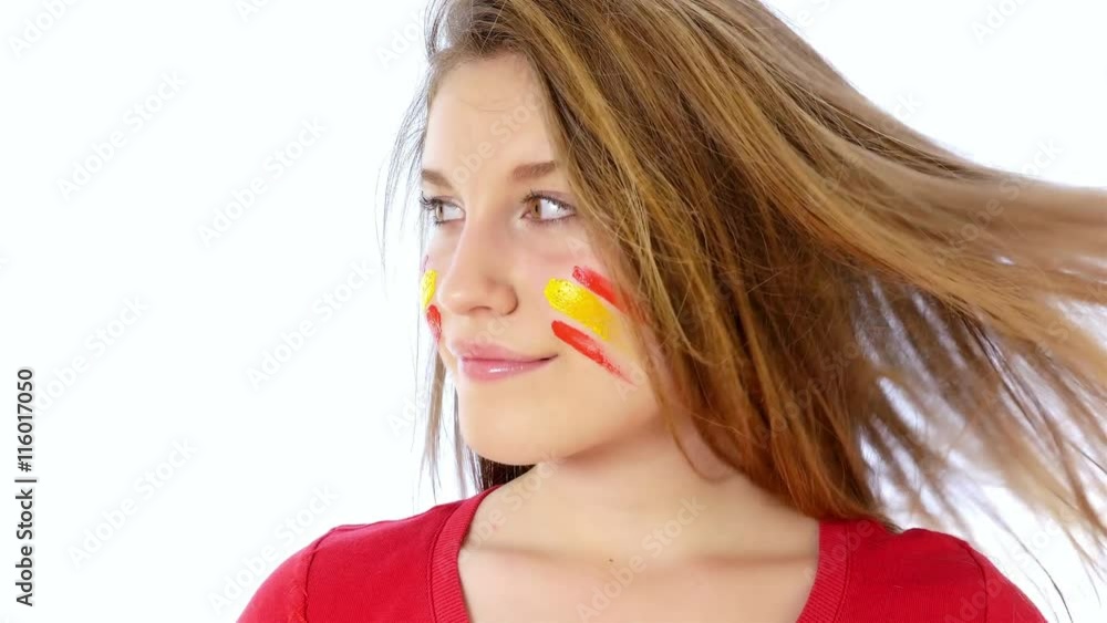 Girl with Spanish flag on her face smiling Girl with Spanish flag on her face smiling
