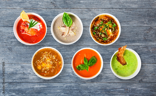 Variety of soups at blue wood, top view