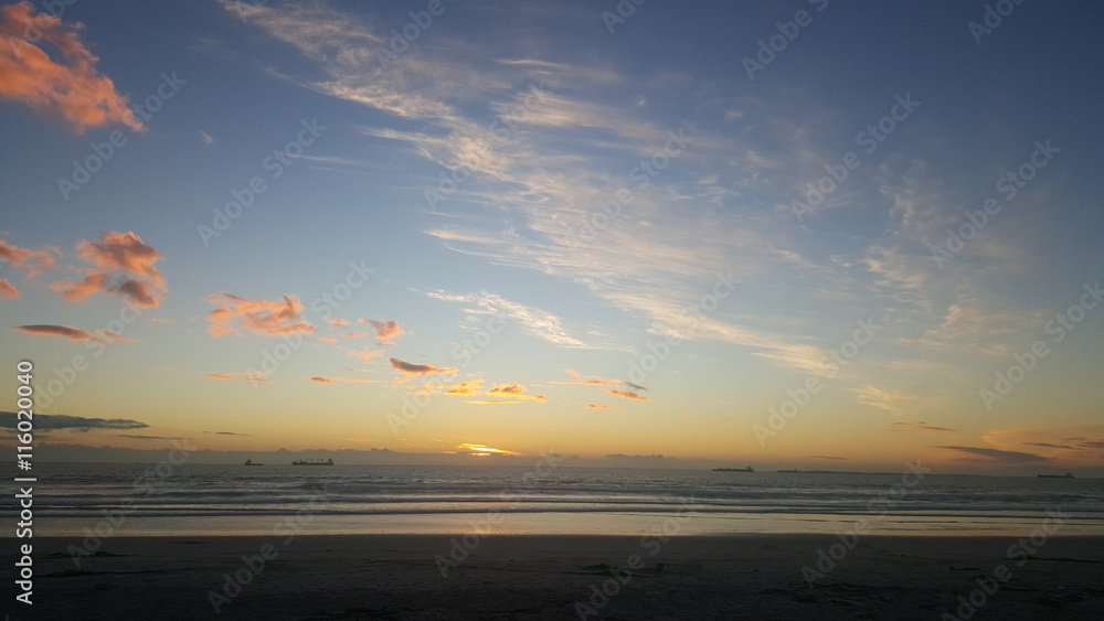 Picturesque sunset and clouds over the beach Picturesque sunset and clouds over the beach