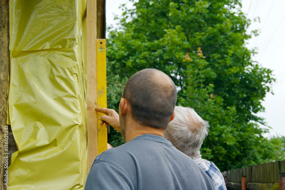 The man is engaged in construction work on the exterior isulation of the house with mineral wool
The man is engaged in construction work on the exterior isulation of the house with mineral wool