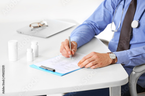 Doctor working at table in ...