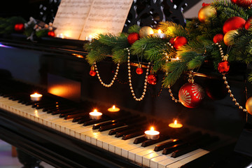 Piano keys with Christmas decorations, closeup
