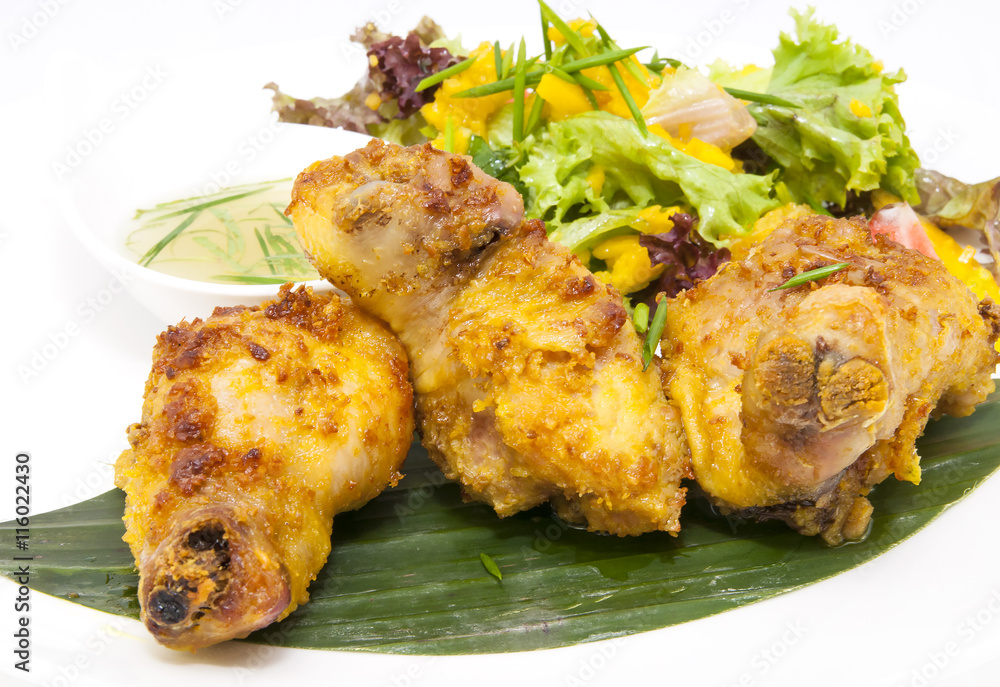 chicken in curry with salad and sauce on a white background in restorne chicken in curry with salad and sauce on a white background in restorne