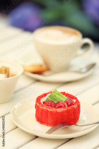 Strawberry biscuit cake in white plate on light wooden table