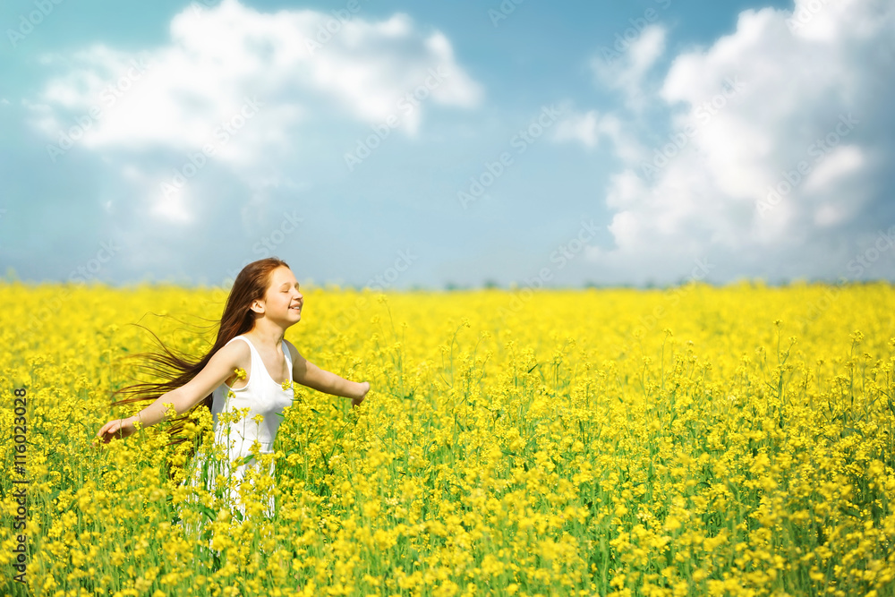 Sweet girl in meadow with wild spring flowers Sweet girl in meadow with wild spring flowers