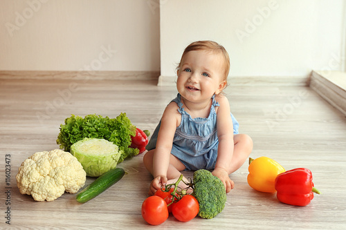 Cute baby girl with vegetab...