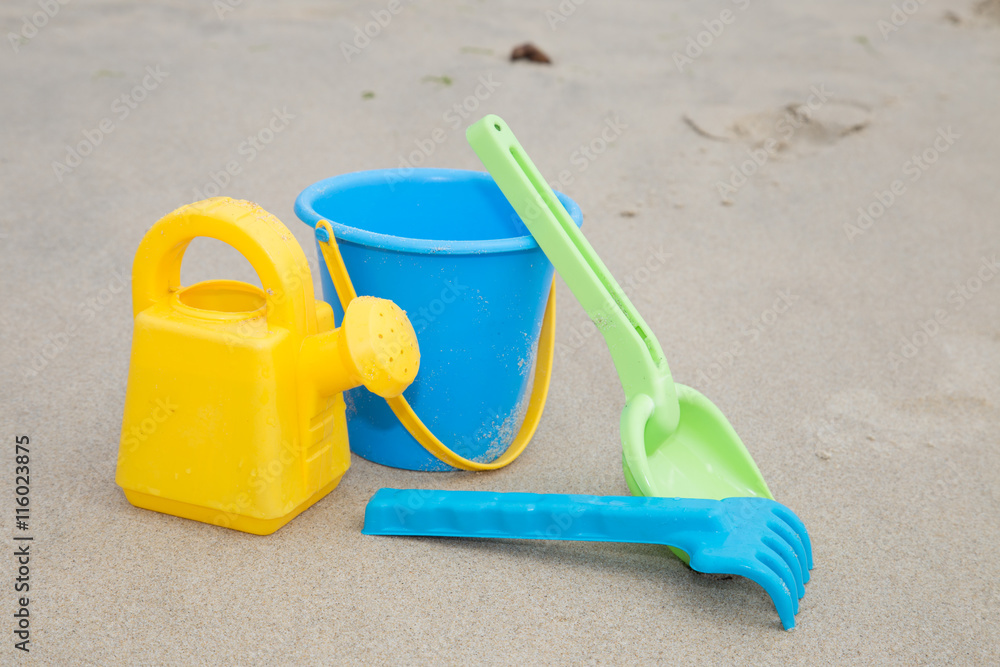 Beach toys in the sand at the beach Beach toys in the sand at the beach