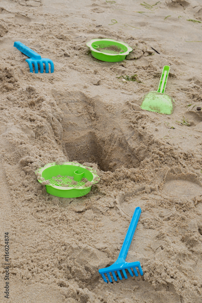 Child's toys on sandy beach, summer holidays concept Child's toys on sandy beach, summer holidays concept