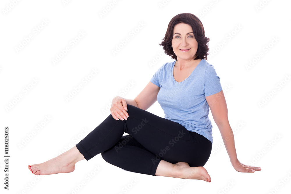 mature woman in sportswear sitting isolated on white