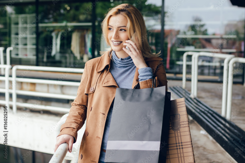 Outdoor portrait of cute happy blonde Caucasian girl with talking on smartphone. Outdoor portrait of cute happy blonde Caucasian girl with talking on smartphone.