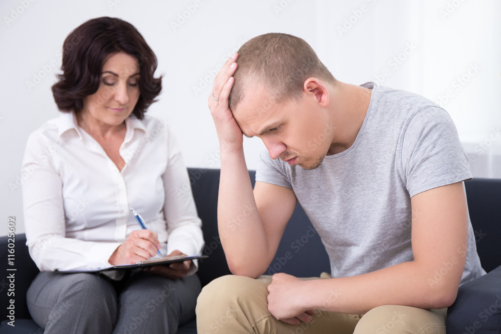 sad man talking with psychotherapist or psychologist sad man talking with psychotherapist or psychologist