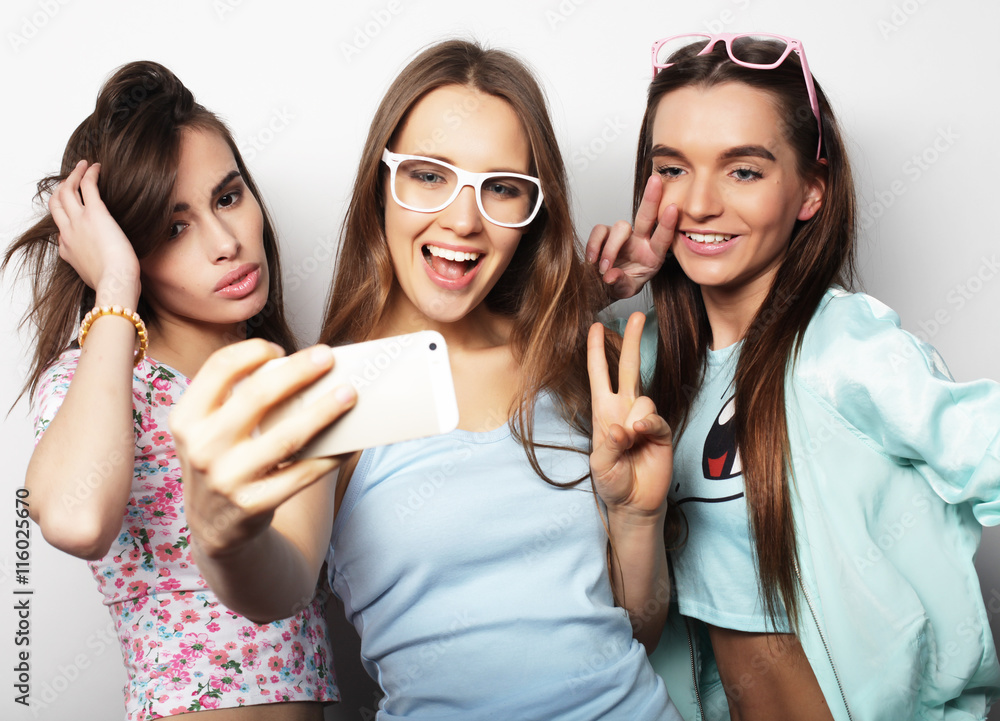 three happy teenage girls with smartphone taking selfie three happy teenage girls with smartphone taking selfie