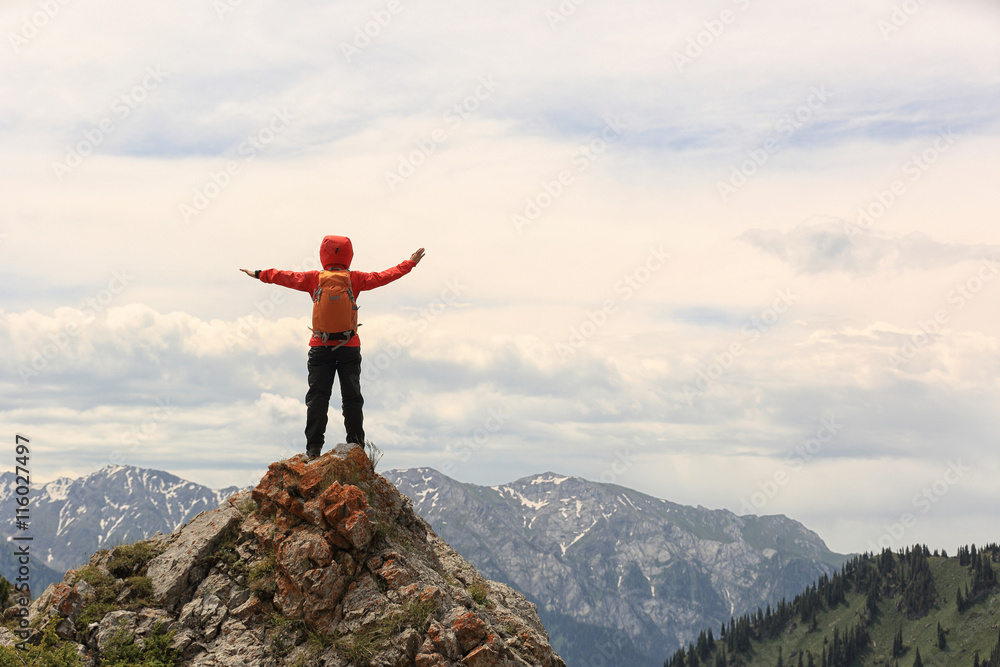 cheering successful woman backpacker open arms on mountain peak cheering successful woman backpacker open arms on mountain peak
