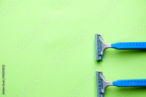 The image of blue razor blades ona a green bakground