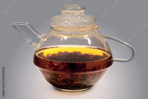 Glass teapot with strong tea photo