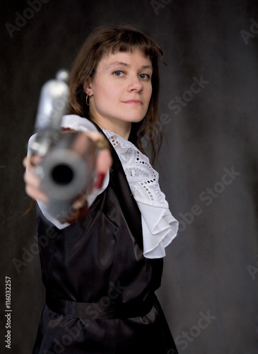 The girl - pirate with ancient pistol in hand photo