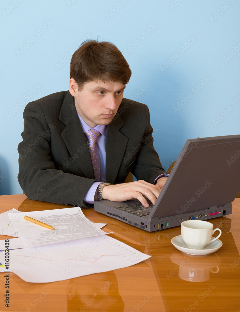 Businessman on a workplace with the laptop Businessman on a workplace with the laptop