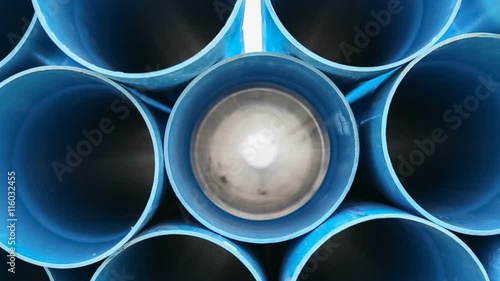 PVC pipes stacked in warehouse , dolly right shot