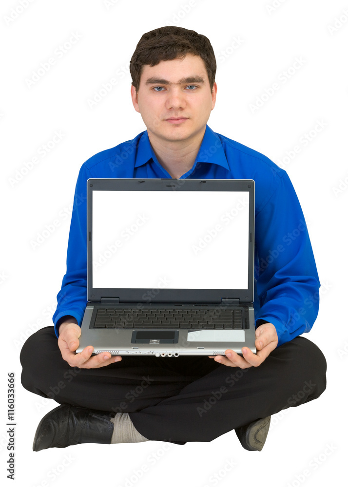 Guy sits on a floor with the laptop Guy sits on a floor with the laptop