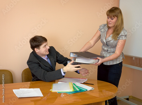 Secretary gives a folders to the chief photo