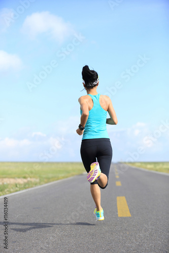 healthy lifestyle young fitness woman runner running on road © lzf
