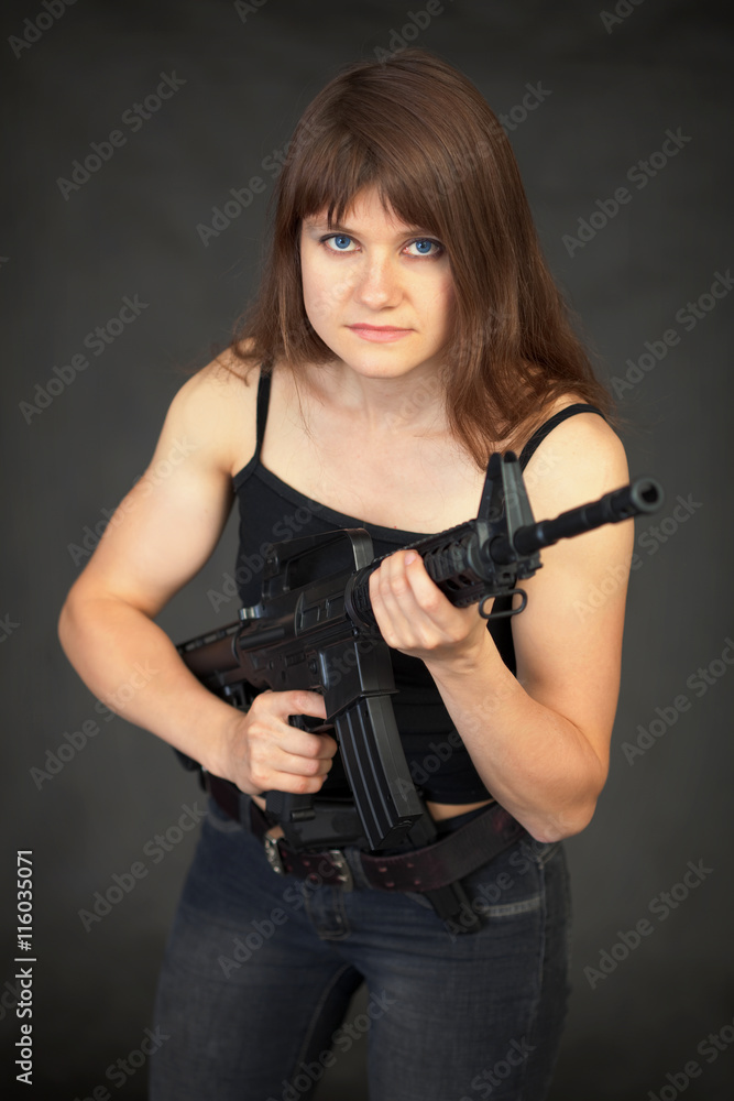 Beautiful young sexual woman - soldier with a rifle Beautiful young sexual woman - soldier with a rifle