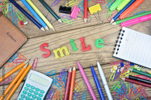 Smile word and office tools on wooden table
