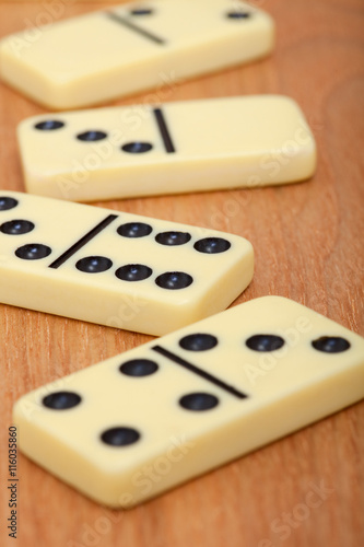 Bones of dominoes on wooden background close up