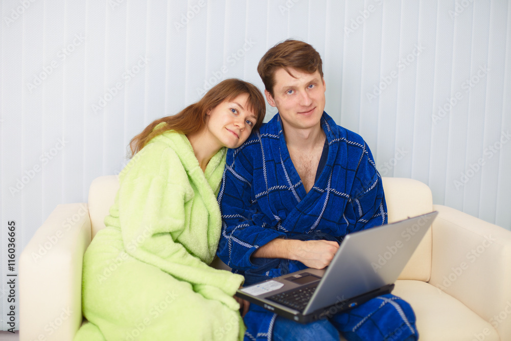Young couple on sofa with laptop Young couple on sofa with laptop